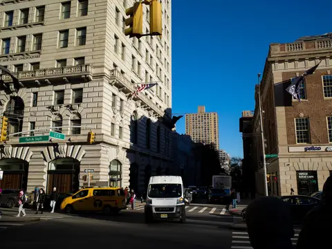 Park Avenue South in Manhattan on a clear morning, stone buildings and a yellow cab
