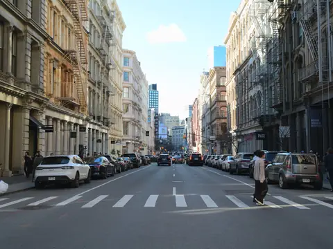 A SoHo street in Manhattan with cast-iron buildings and a wide crosswalk